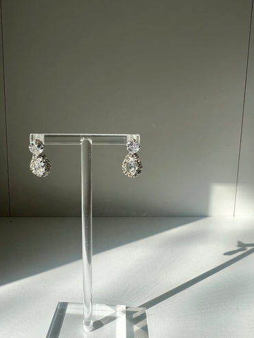 Elegant Imogen diamond earrings showcased on a transparent holder