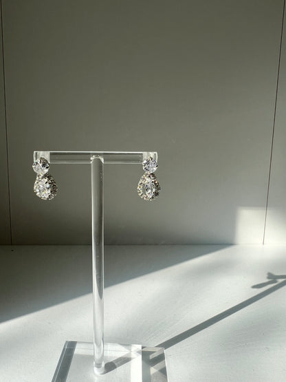 Elegant Imogen diamond earrings showcased on a transparent holder