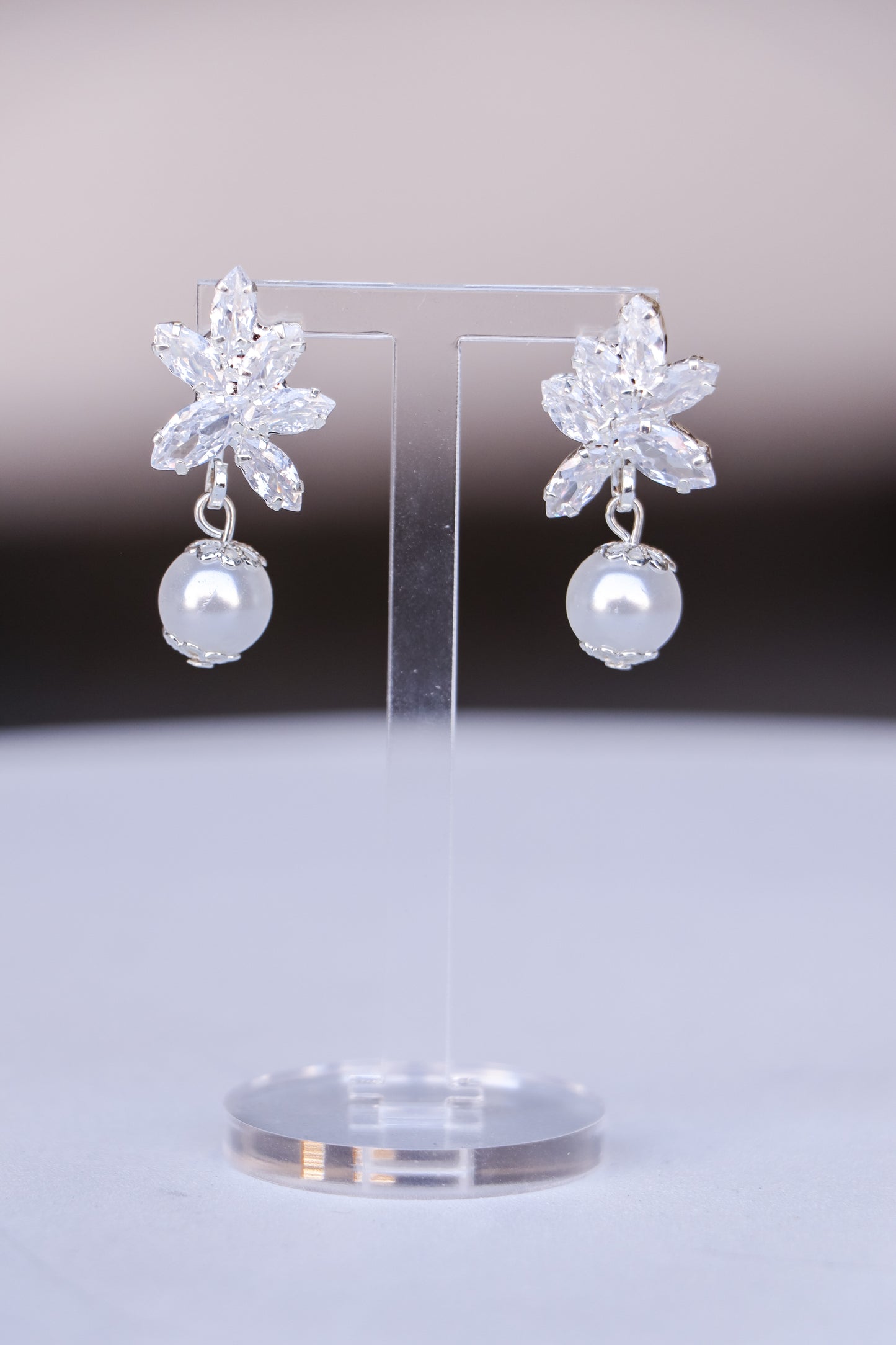 A pair of elegant pearl  Fleur earrings with sparkling gemstones
