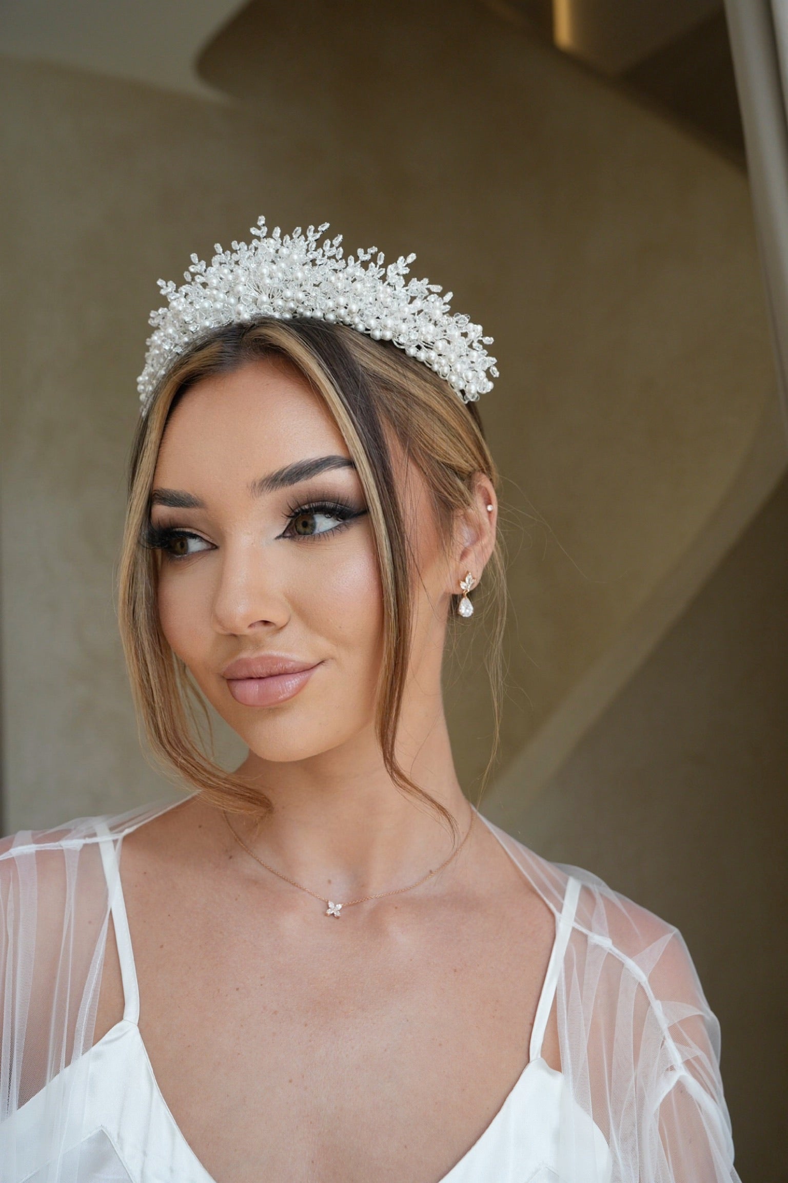 A stunning bride with a tiara and a dazzling Jasmine Gold Plated earrings