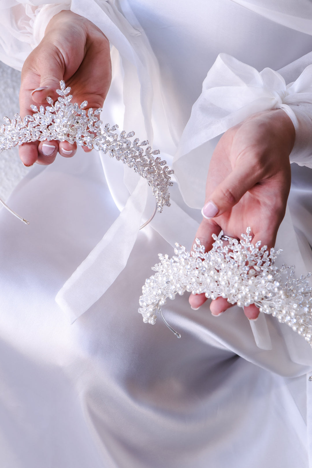 white tiaras featuring crystals, pearls and cubic zirconia