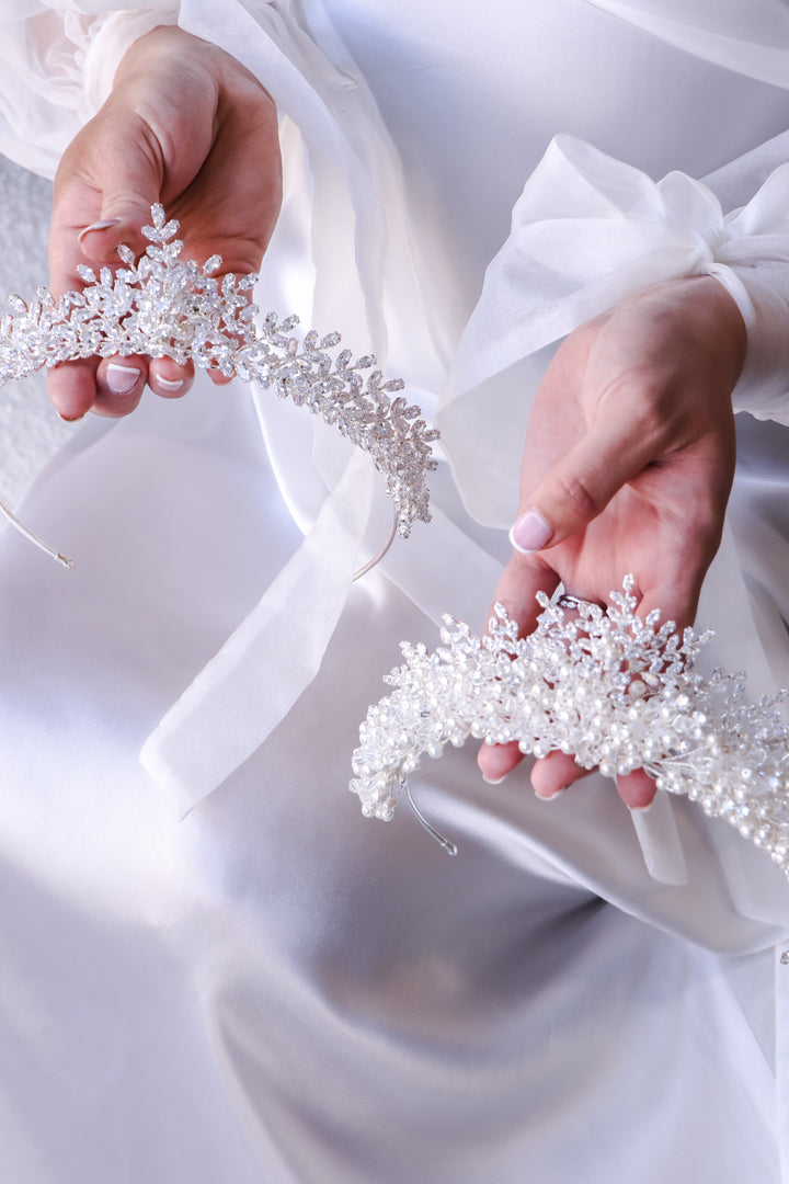 white tiaras featuring crystals, pearls and cubic zirconia