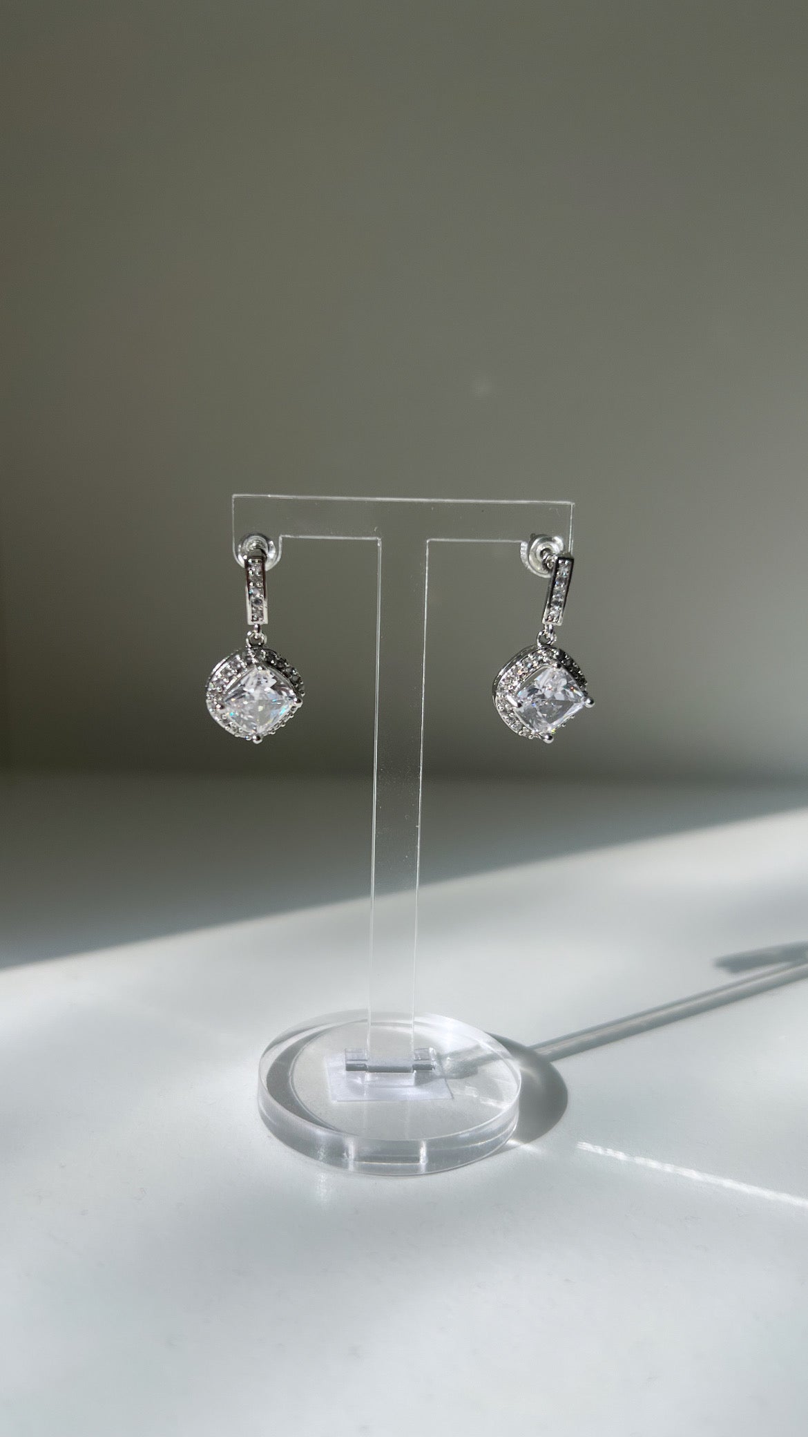 A pair of Daphne earrings with diamond accents
