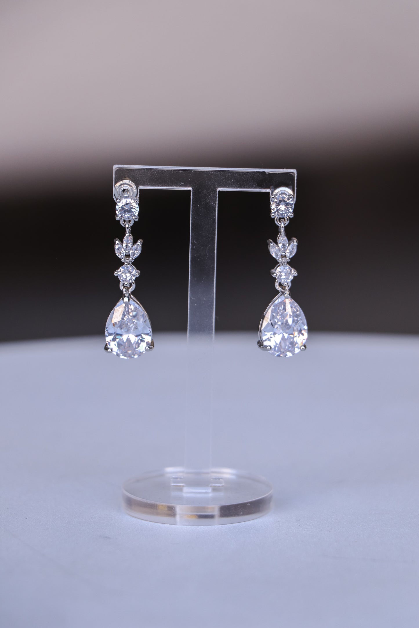 Pair of elegant Cassia earrings with intricate design and sparkling gemstones