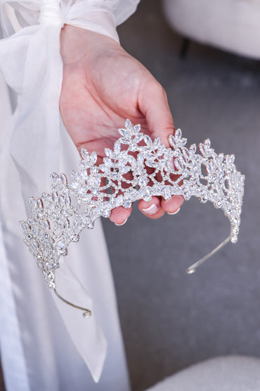 Female holding a bridal tiara adorned with dazzling diamonds