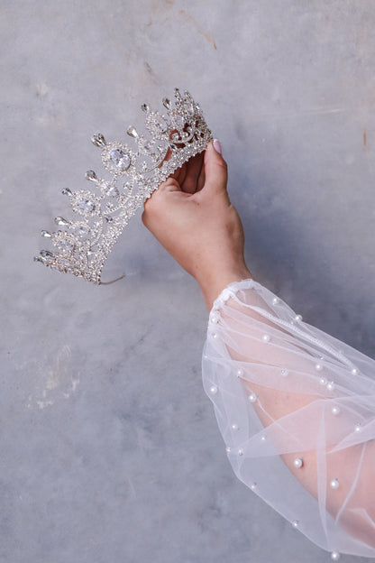 A woman holding elegant Eylul bridal tiara for a princess-like wedding