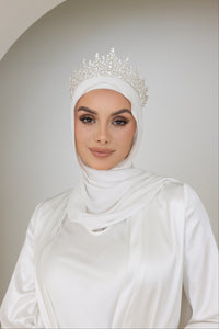A stunning woman in a white hijab and sparkling Hazel bridal tiara, radiating elegance and grace