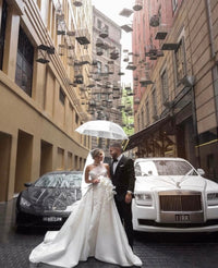 A couple facing each other under a clear umbrella