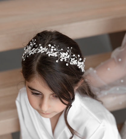 A beautiful girl wearing Celine tiara with pearls and crystals on her head