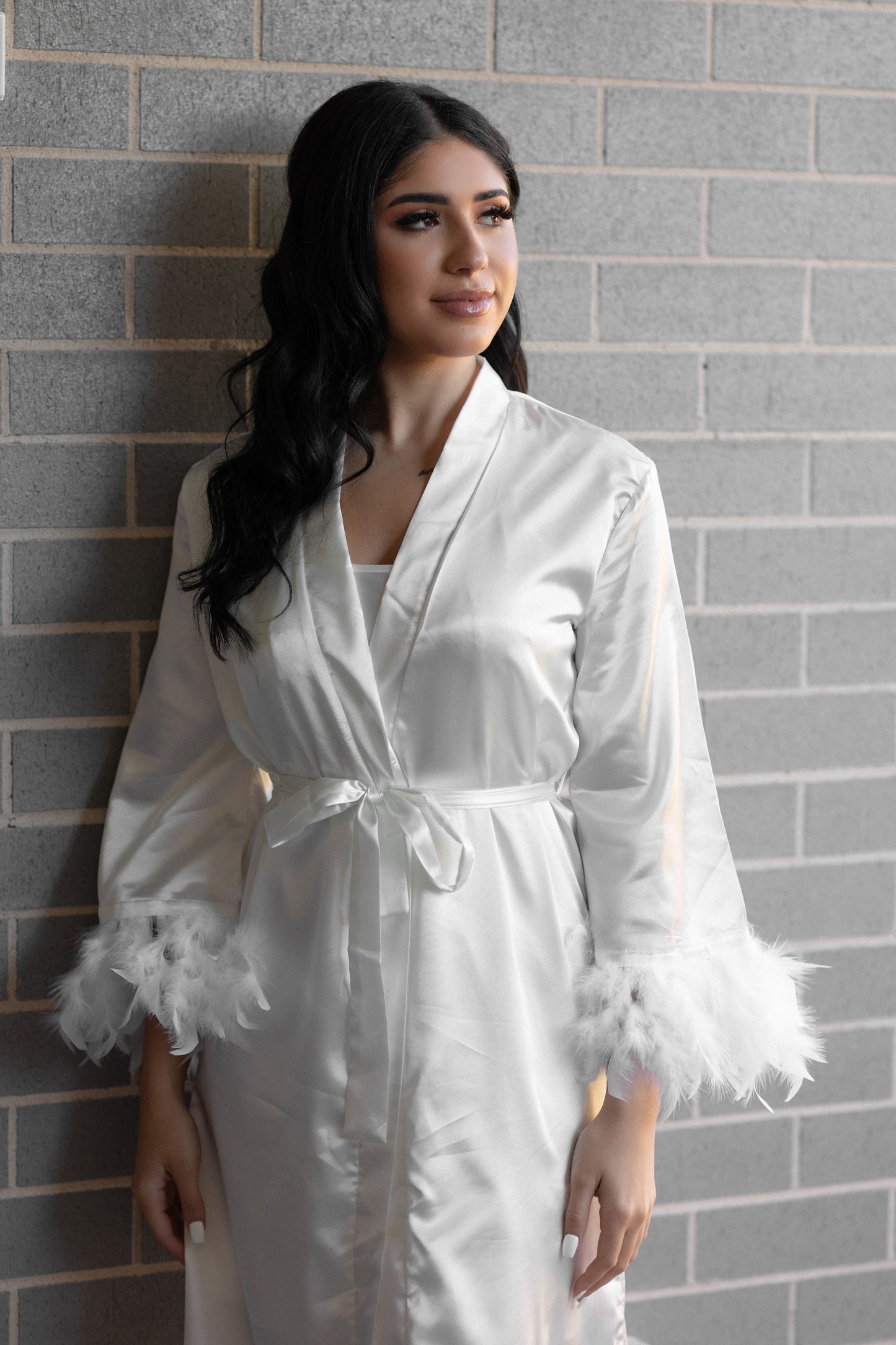 Bride in luxurious white robe posing for a photo
